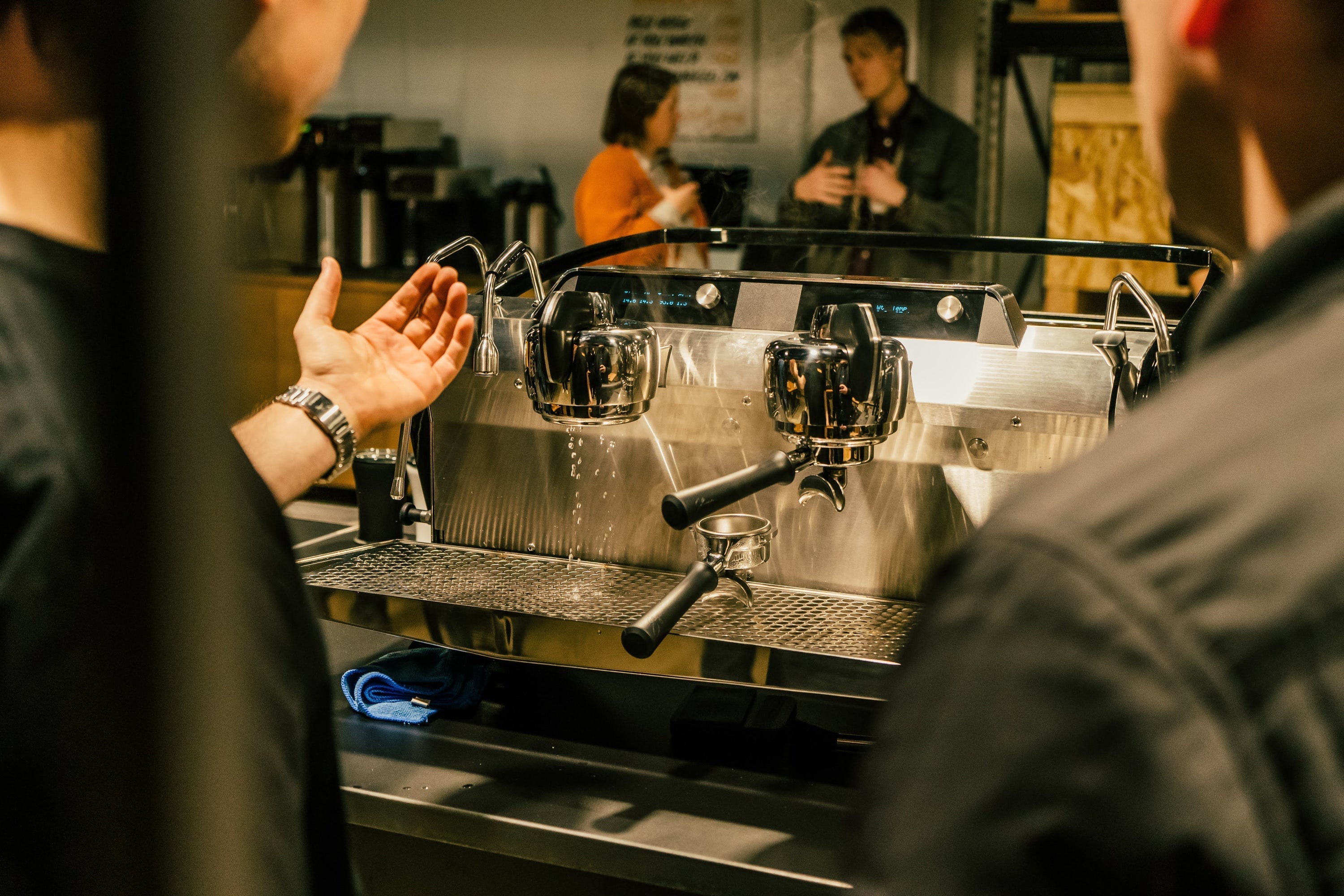 Barista back flushing a Slayer espresso machine group head